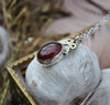 PENDANT, A Pool of Garnet Wrapped in Bows